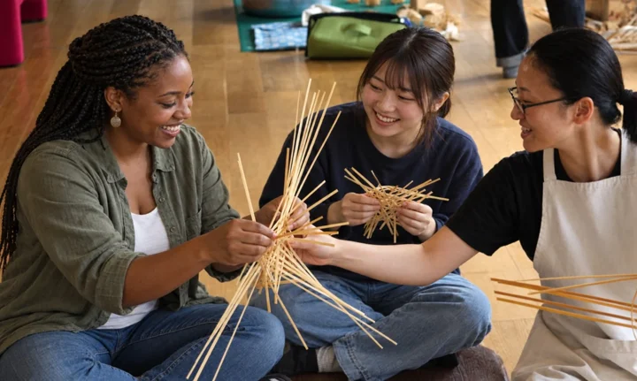 Visitors learning bamboo weaving together