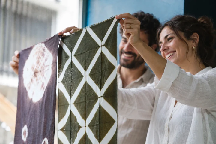 Travelers showing patterned dyed cloth