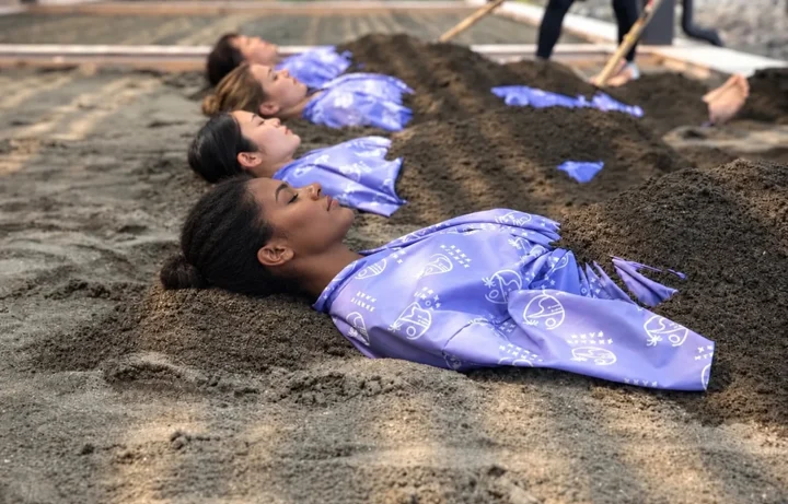 Guests resting in warm sand baths